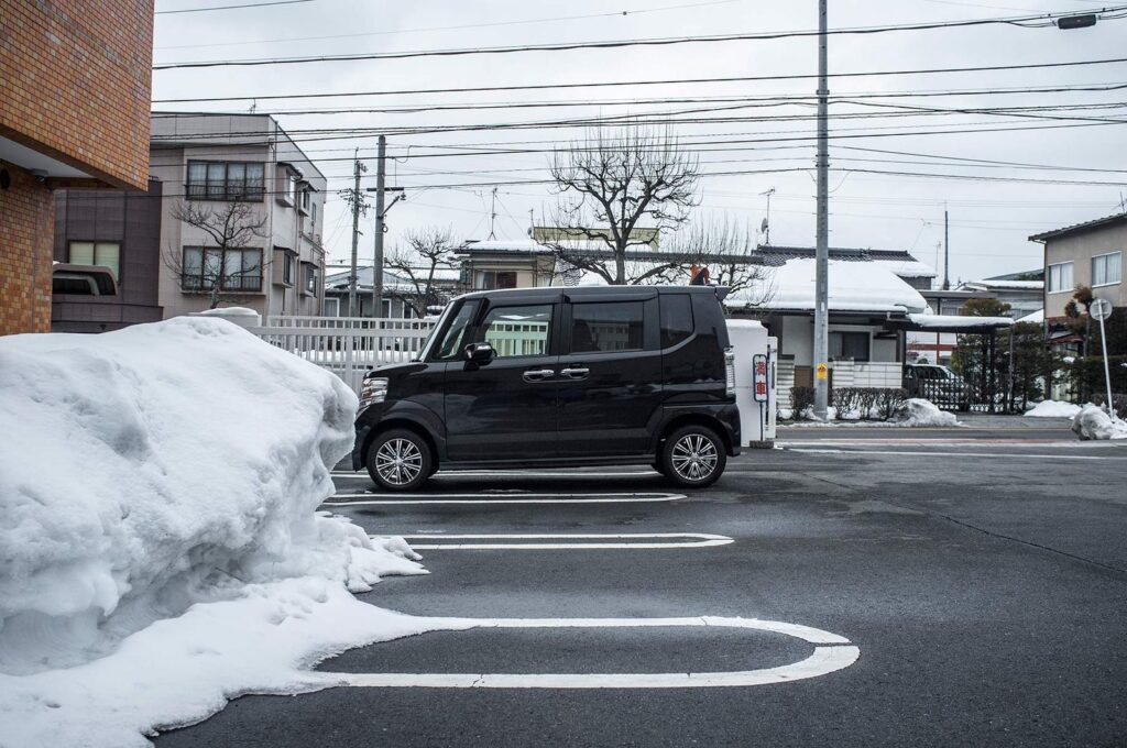 Black kei car in a Japanese car park