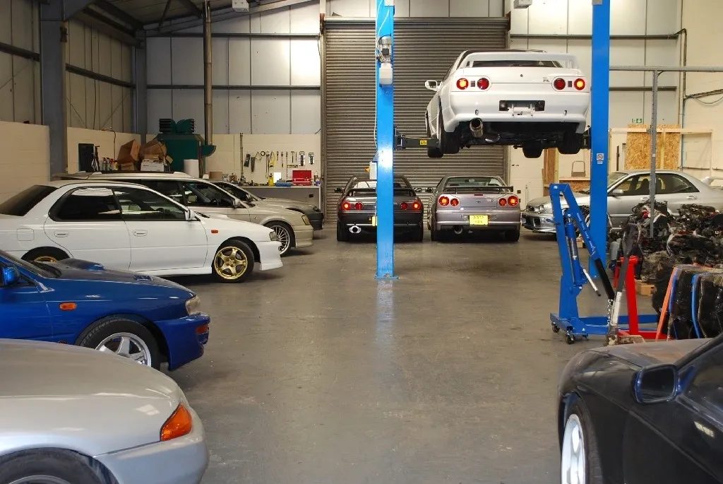 Used Japanese cars being inspected in an export workshop in Japan