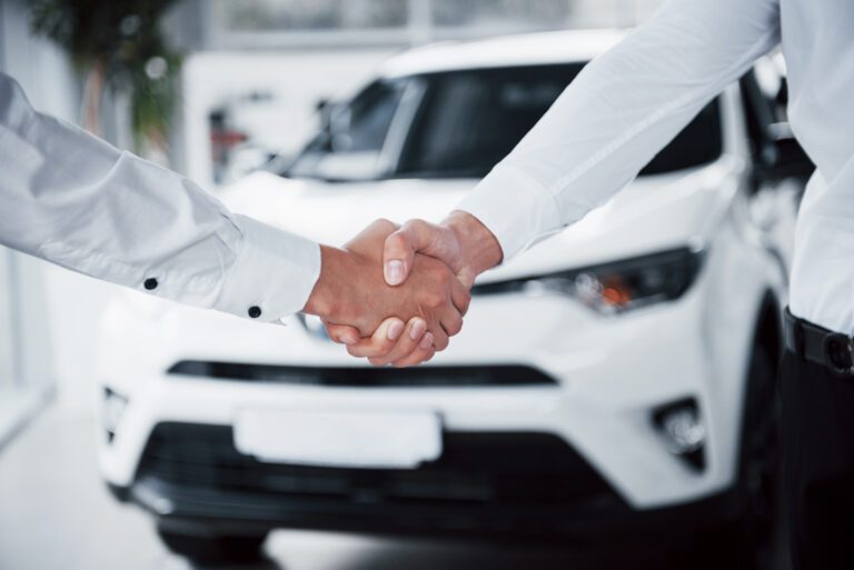Handshake closing a used car export deal with Shams International