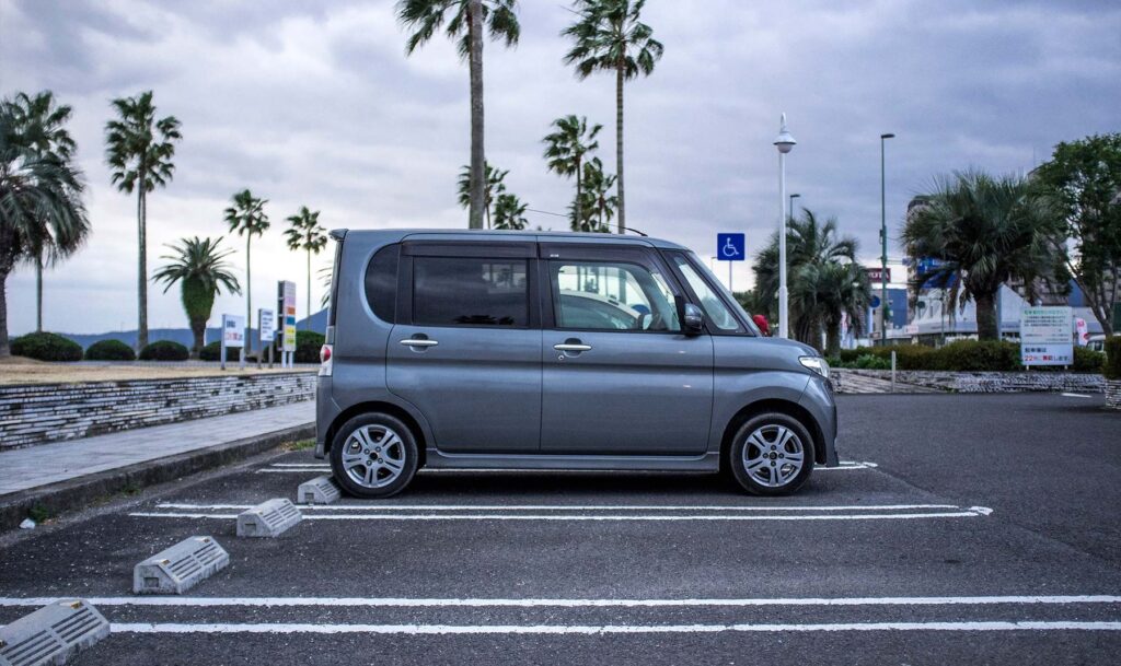 Kei car on a street in Japan, a popular compact used car