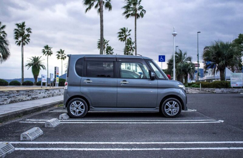 Kei car on a street in Japan, a popular compact used car
