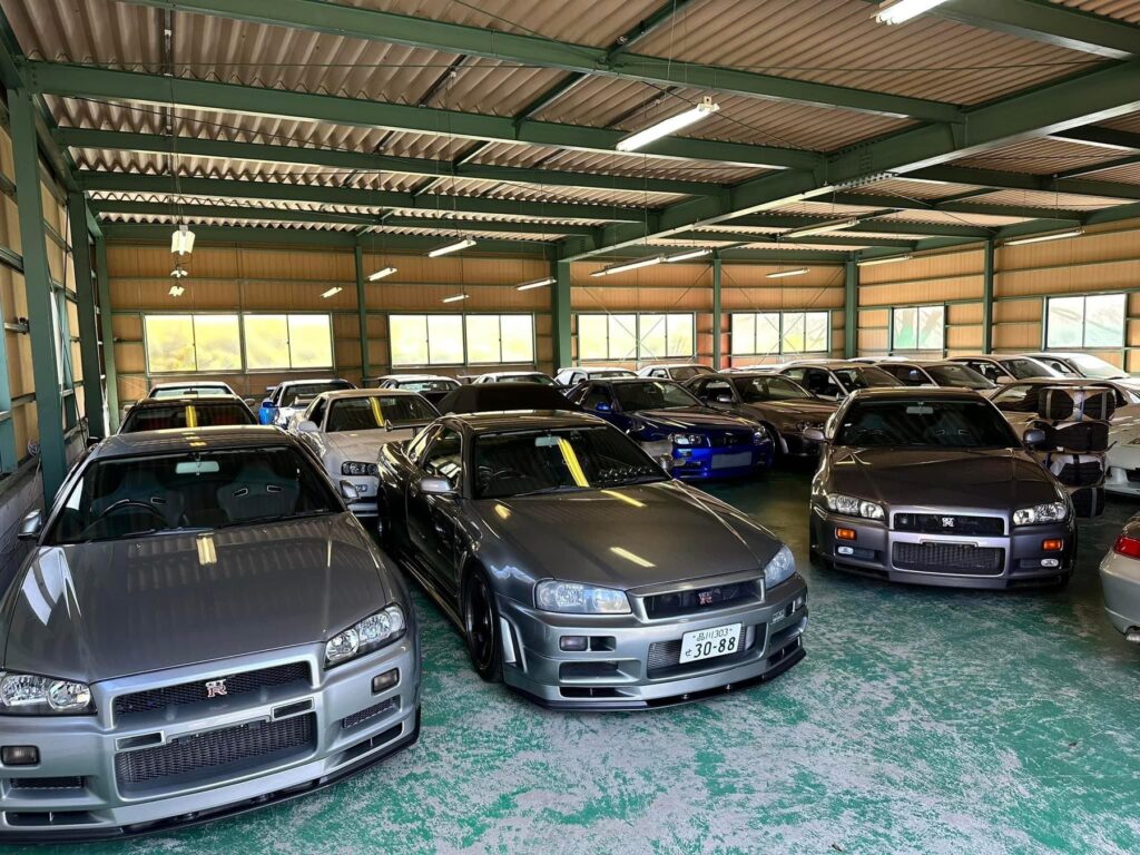 Nissan Skyline and other Japanese used cars in a showroom